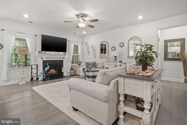 living room featuring hardwood / wood-style flooring and ceiling fan