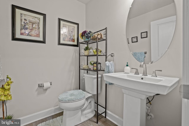 bathroom with toilet and hardwood / wood-style floors