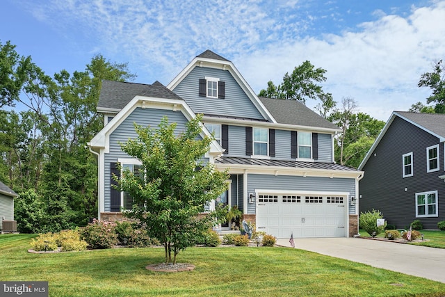 view of front of house with a garage and a front lawn