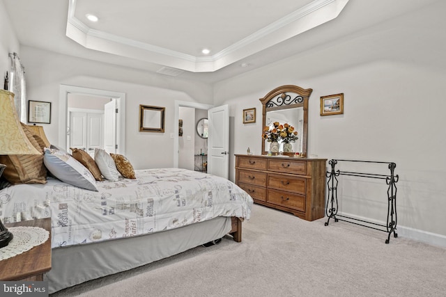 carpeted bedroom with crown molding and a tray ceiling