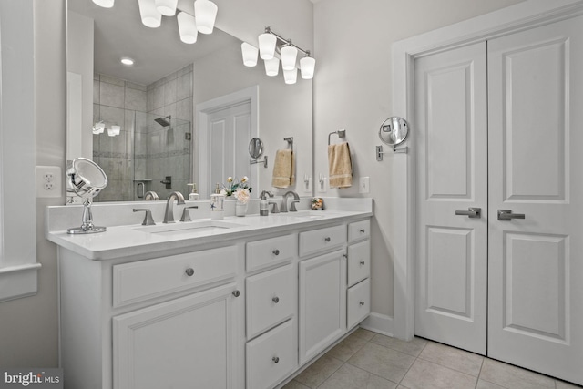 bathroom featuring tile patterned floors, vanity, and a shower with door