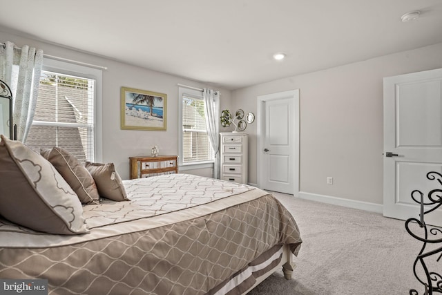 bedroom featuring light carpet