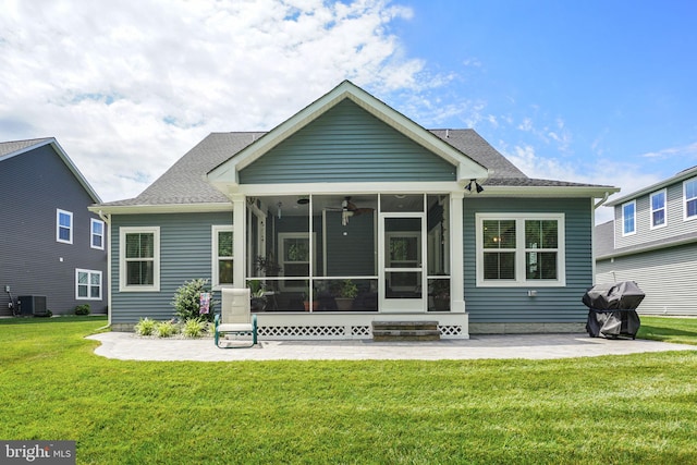 back of property featuring a yard, a patio area, a sunroom, and central air condition unit