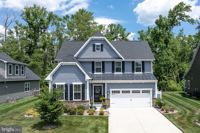 view of front of house with a garage and a front yard