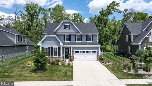 view of front facade featuring a garage, central AC, and a front yard