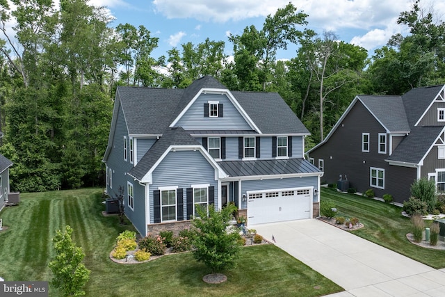 view of front of house featuring a garage, central AC unit, and a front lawn