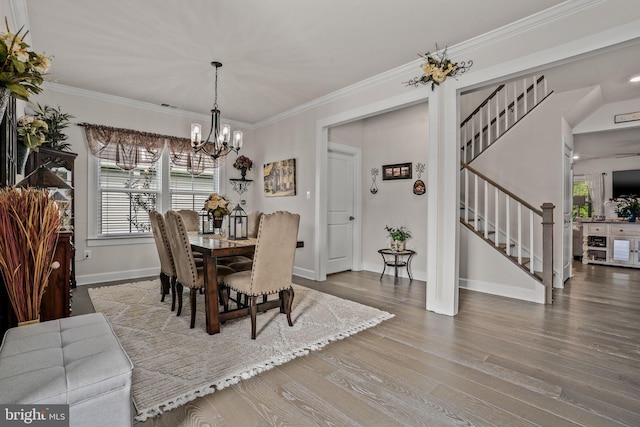 dining room featuring hardwood / wood-style flooring, crown molding, and a chandelier