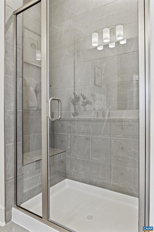 bathroom with a shower with door