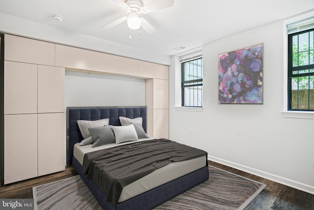 bedroom with ceiling fan and dark hardwood / wood-style flooring