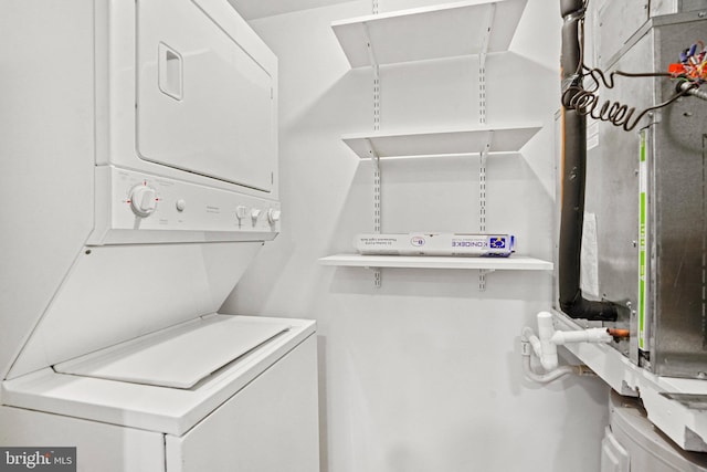 laundry area with stacked washer and clothes dryer