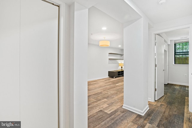 hallway with dark hardwood / wood-style flooring