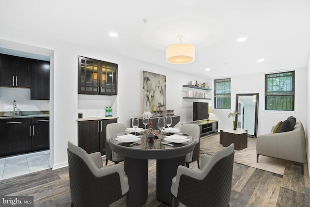 dining room with sink and wood-type flooring