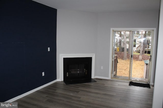 unfurnished living room featuring dark wood-type flooring