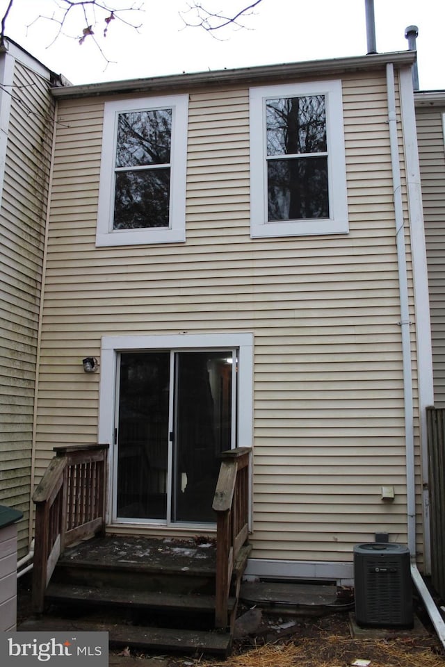 rear view of house with central AC unit