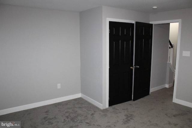 unfurnished bedroom with a closet and carpet