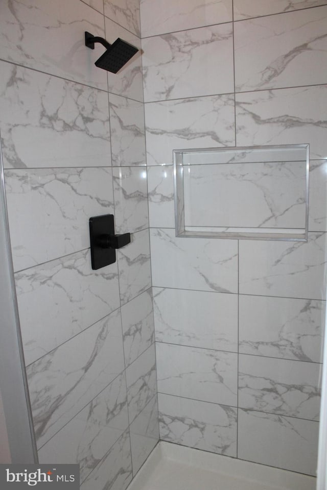 bathroom with a tile shower