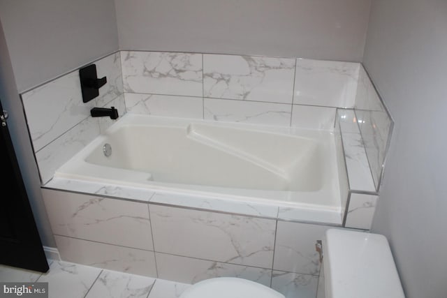 bathroom with tiled bath and toilet