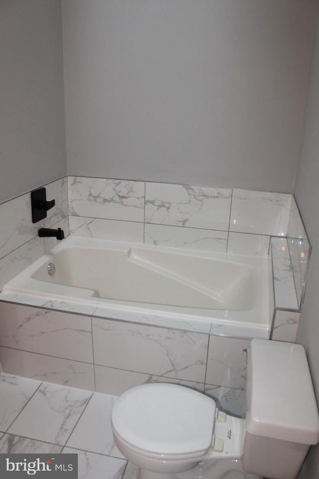 bathroom with tiled bath and toilet