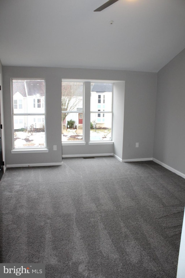 spare room featuring ceiling fan and carpet