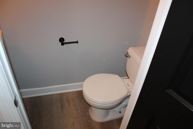 bathroom featuring wood-type flooring and toilet