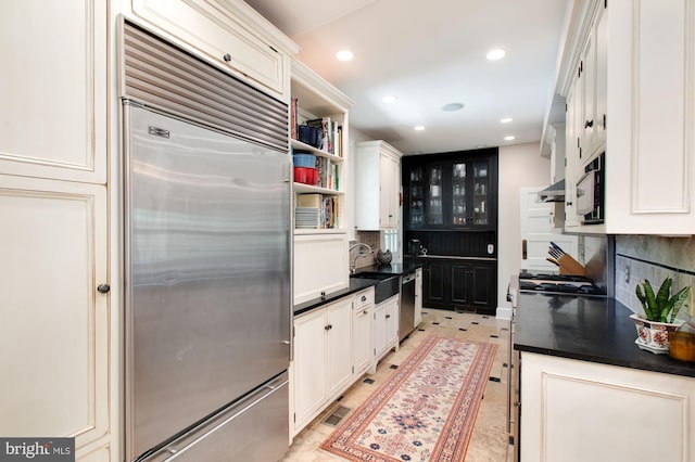 kitchen with white cabinetry, tasteful backsplash, and stainless steel appliances