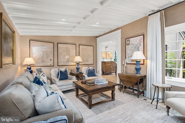 living room with coffered ceiling and beamed ceiling