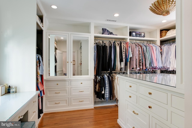 spacious closet featuring light hardwood / wood-style flooring