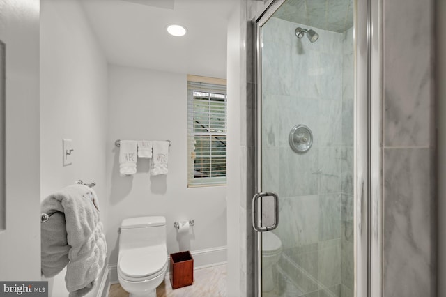 bathroom featuring an enclosed shower and toilet