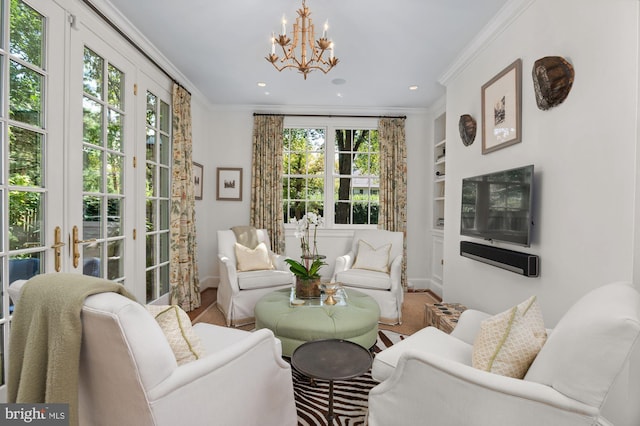 living room with a notable chandelier, crown molding, and built in features