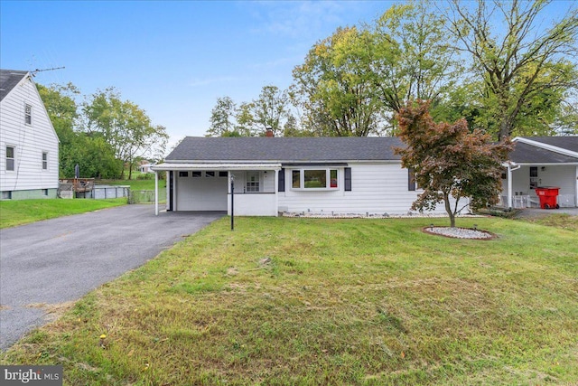 ranch-style home with a carport and a front lawn