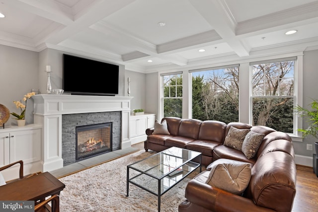 living room with coffered ceiling, beam ceiling, a fireplace, and a healthy amount of sunlight