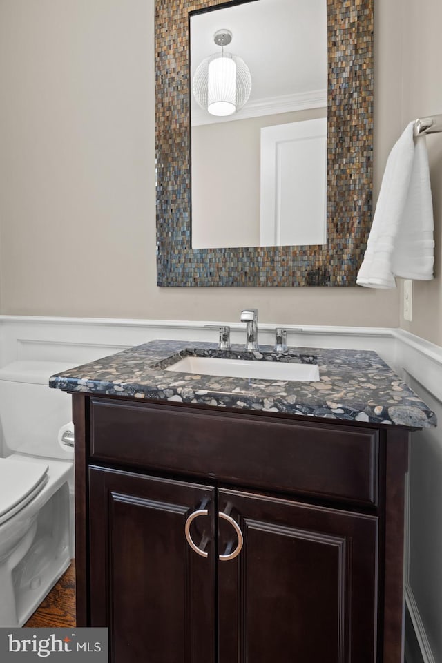 bathroom featuring vanity and toilet