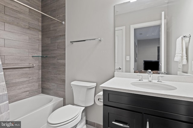 full bathroom featuring vanity, tiled shower / bath, and toilet