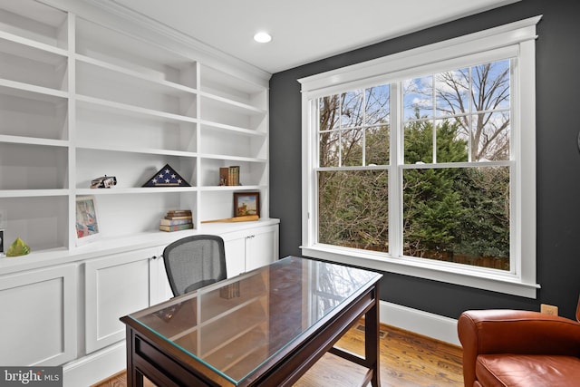 home office with light hardwood / wood-style floors