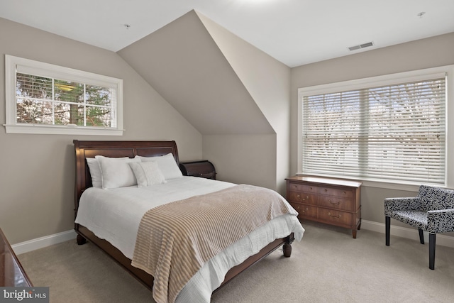 carpeted bedroom with multiple windows and lofted ceiling