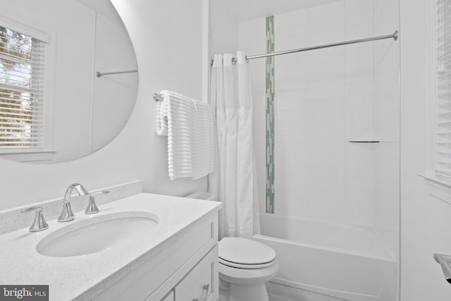 full bathroom featuring vanity, toilet, and shower / tub combo with curtain