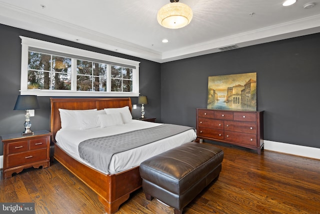 bedroom with crown molding and dark wood-type flooring