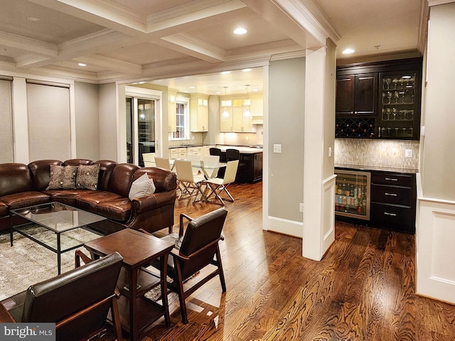 living room with ornamental molding, bar area, dark hardwood / wood-style flooring, beverage cooler, and beamed ceiling