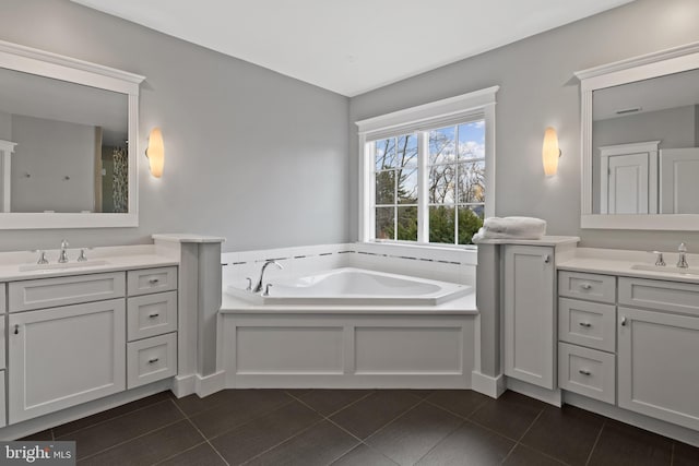 bathroom featuring vanity, tile patterned floors, and a bathtub