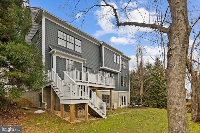 back of house featuring a deck and a lawn