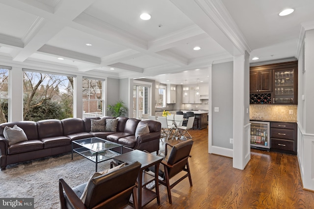 living room with coffered ceiling, beam ceiling, indoor bar, dark hardwood / wood-style flooring, and beverage cooler