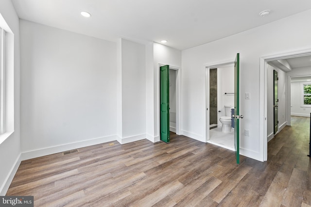 unfurnished room with hardwood / wood-style floors