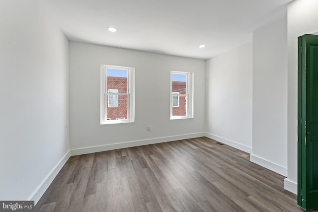 spare room with dark wood-type flooring