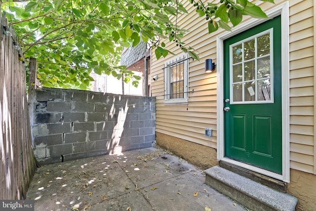 entrance to property featuring a patio area