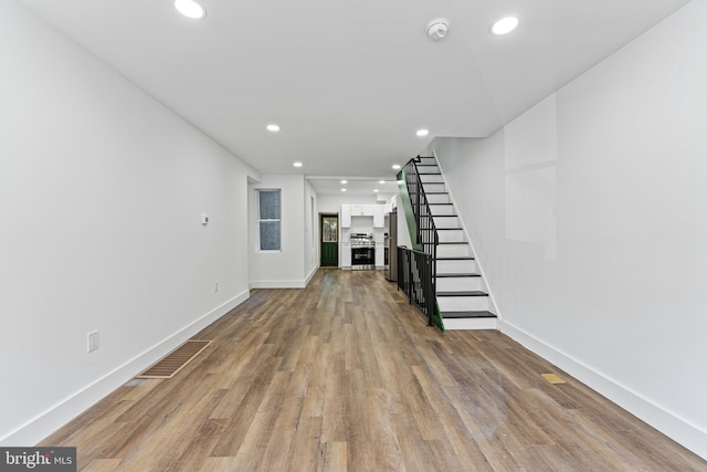 unfurnished living room featuring hardwood / wood-style flooring