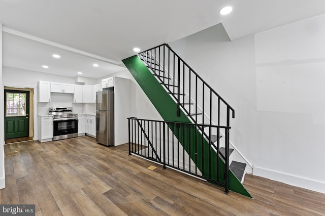 stairway featuring hardwood / wood-style flooring