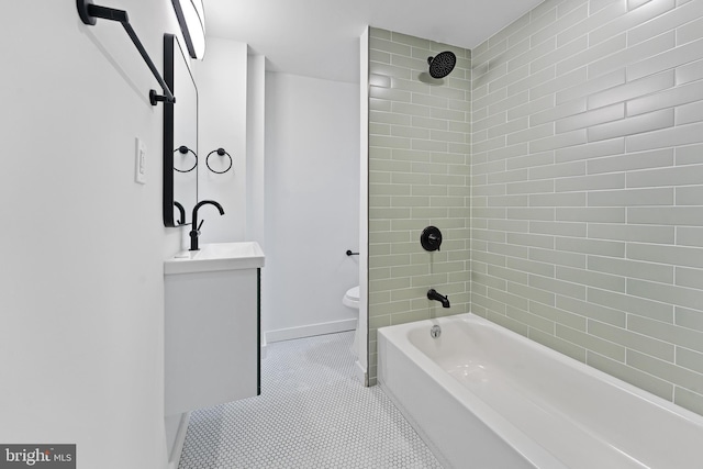 full bathroom with tile patterned floors, vanity, toilet, and tiled shower / bath combo