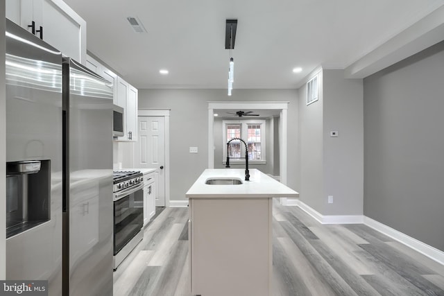 kitchen with white cabinetry, sink, an island with sink, and appliances with stainless steel finishes