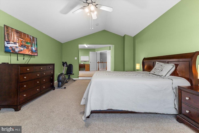 bedroom with vaulted ceiling, light colored carpet, and ceiling fan