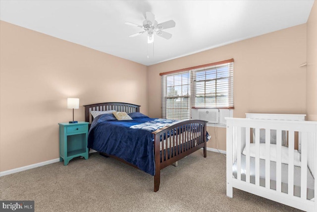 carpeted bedroom featuring ceiling fan, baseboards, and cooling unit